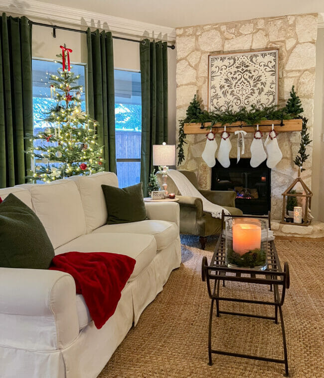 White sofa with Christmas tree, mantel and white holiday stockings