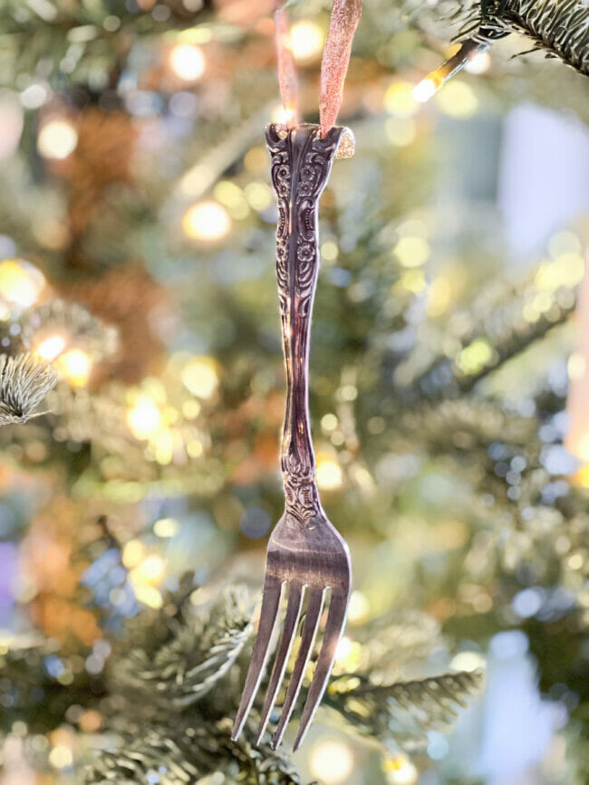 Ornate silver fork hanging on Christmas tree
