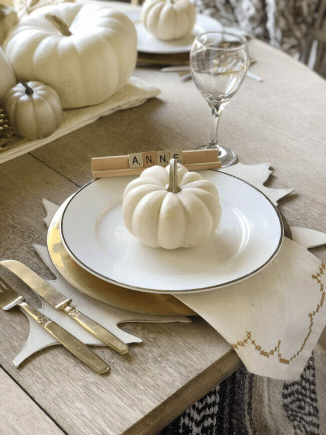 white plate with white pumpkin and silverware with name in game letters