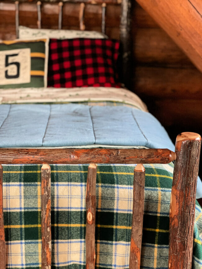 log bed with plaid bedding