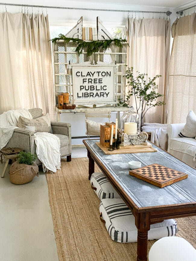 living room with coffee table, chair and sign