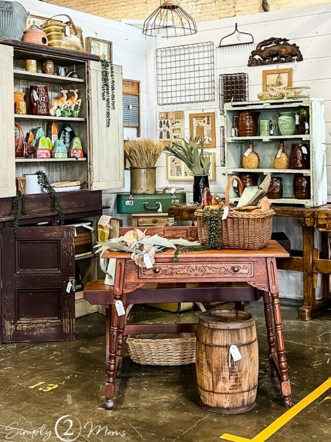 room with antique table, shelves with decor and buckets