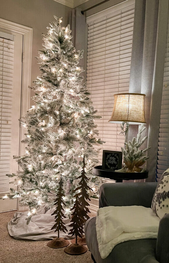 Christmas tree with lamp and gray chair