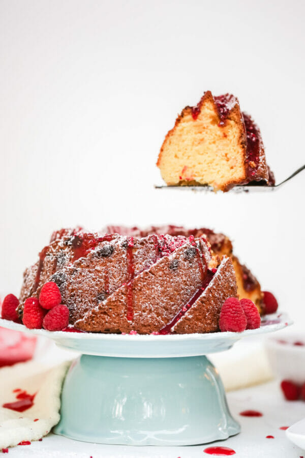 cake on green bowl with slice cut out