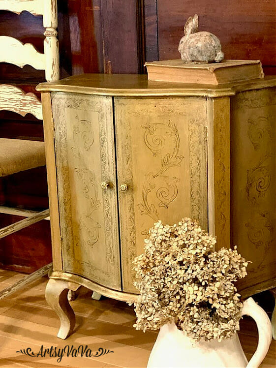 gold 2 door chest with dried hydrangeas on floor