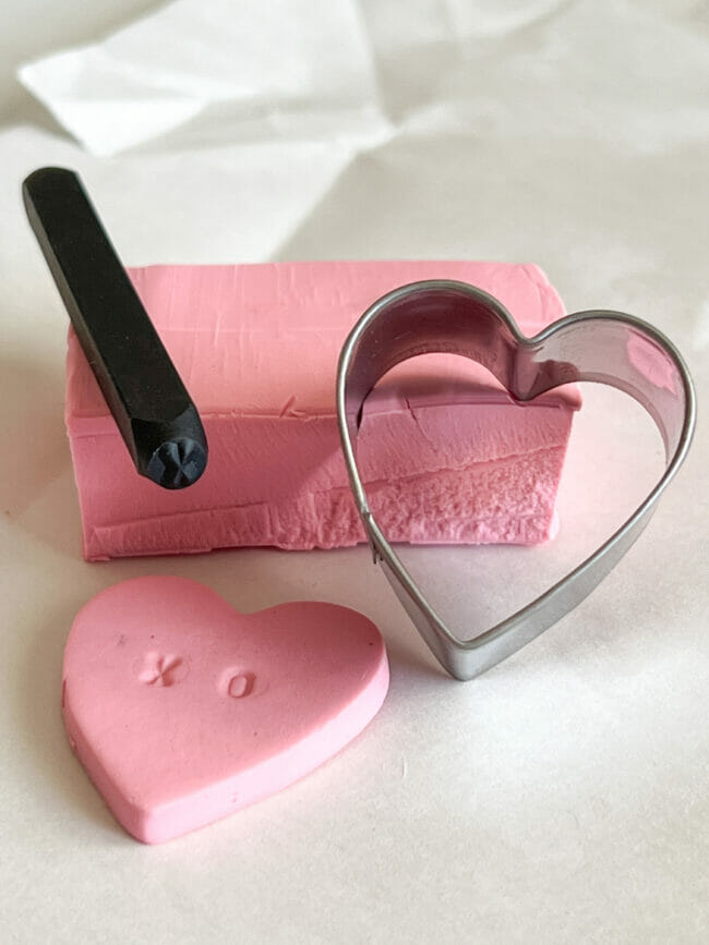 pink clay with heart cookie cutter and metal stamp