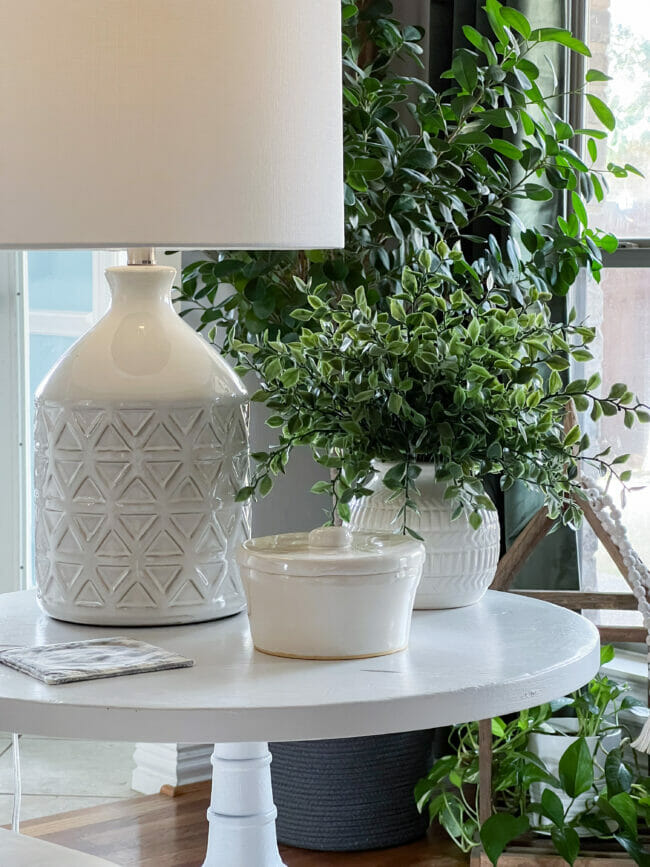 white lamp, bowl and plant on white table