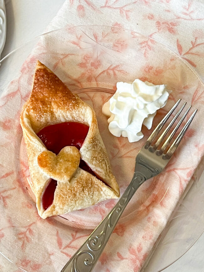 plate with pastry, cream and fork