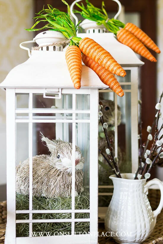 white lanterns with carrots, bunnies and a white pitcher with stems