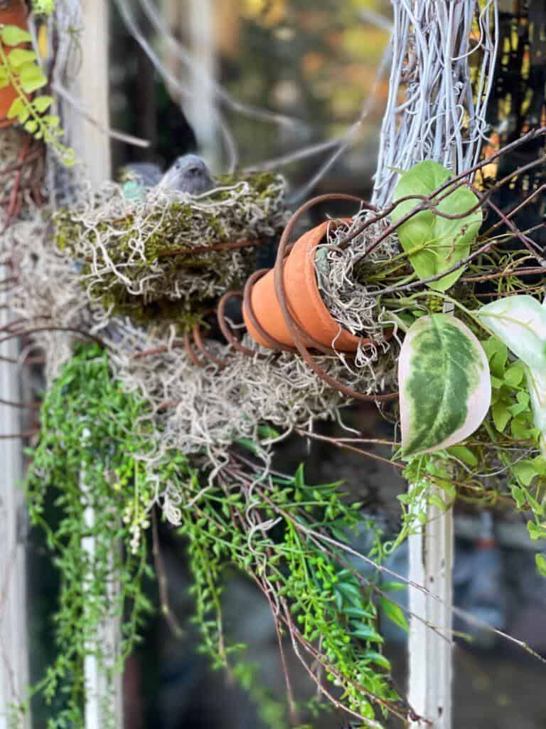 wreath with bed spring, moss and plants