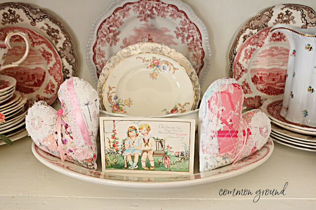 quilted hears, dishes and vintage card on platter