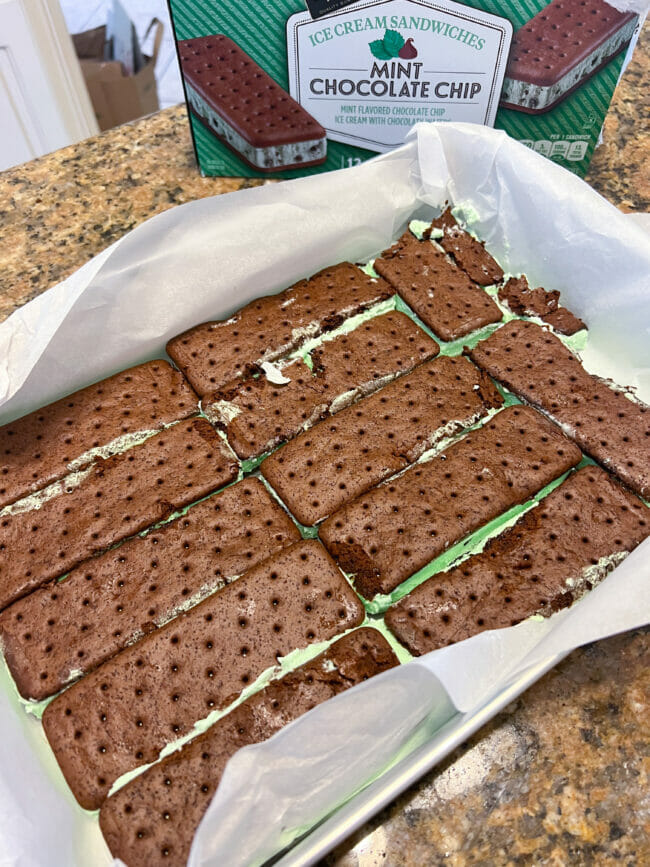 first layer of mint ice cream sandwiches in cake pan