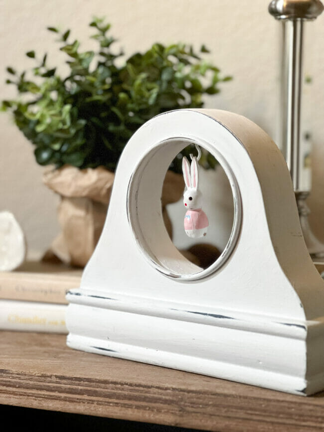 white clock face with bunny hanging inside