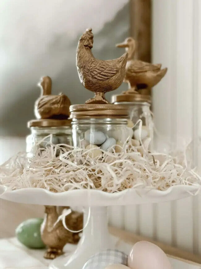 gold animal lids on mason jars with white grass