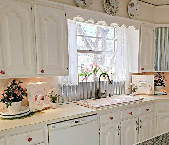 white kitchen with pink flowers and spring decor