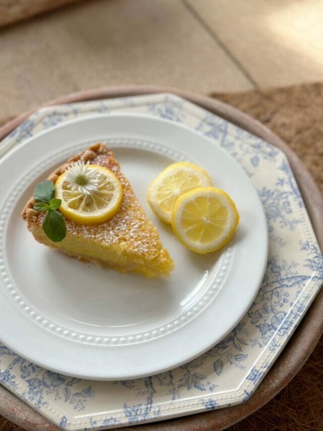 white plate with lemon pie and lemon slices
