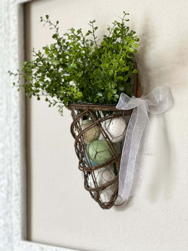 hanging basket with eggs and greenry