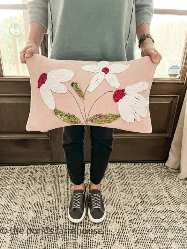 Lady holding a pink floral pillow