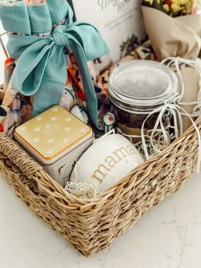 basket of gifts for mom including an apron and jars of food