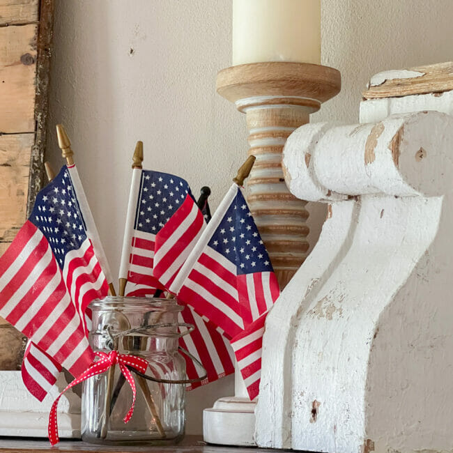 clear jar, mini flags, white chippy salvage piece and candle