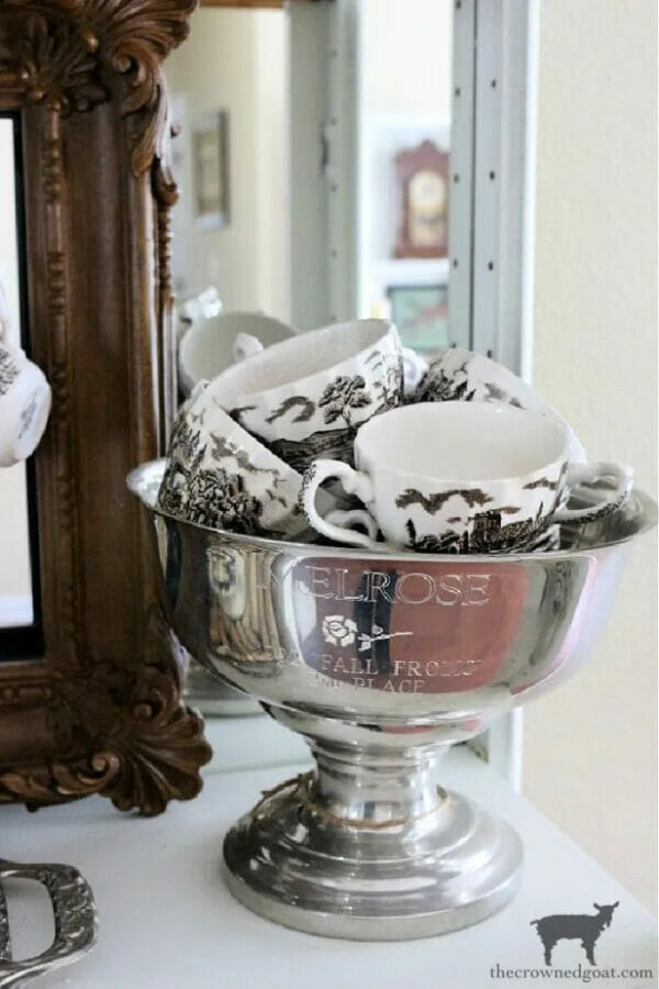 silver bowl with black and whit cups