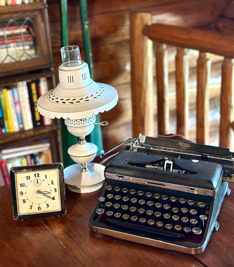 old black typewriter with lamp and clock