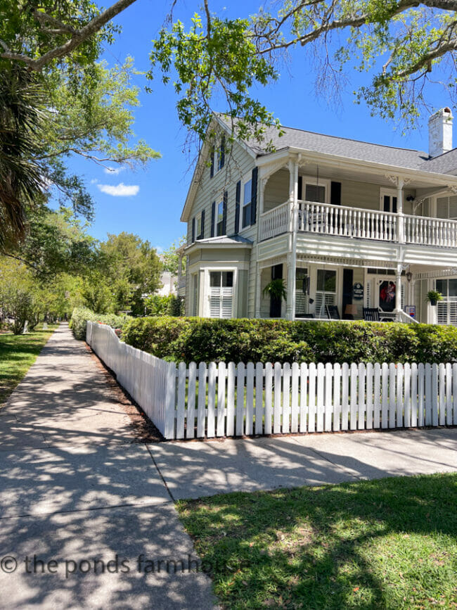 old white home with picket fence