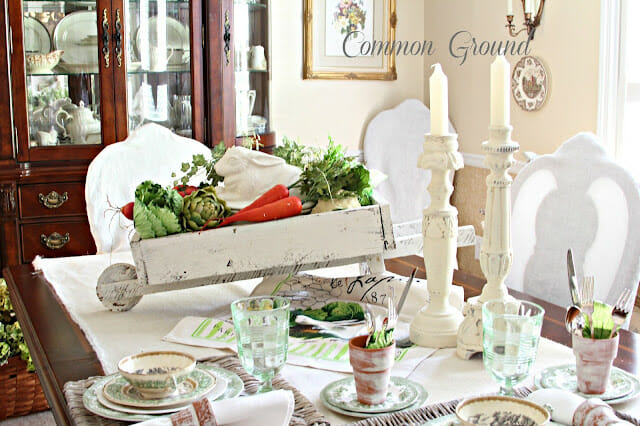 tablescape with white wheelbarrow and garden pieces