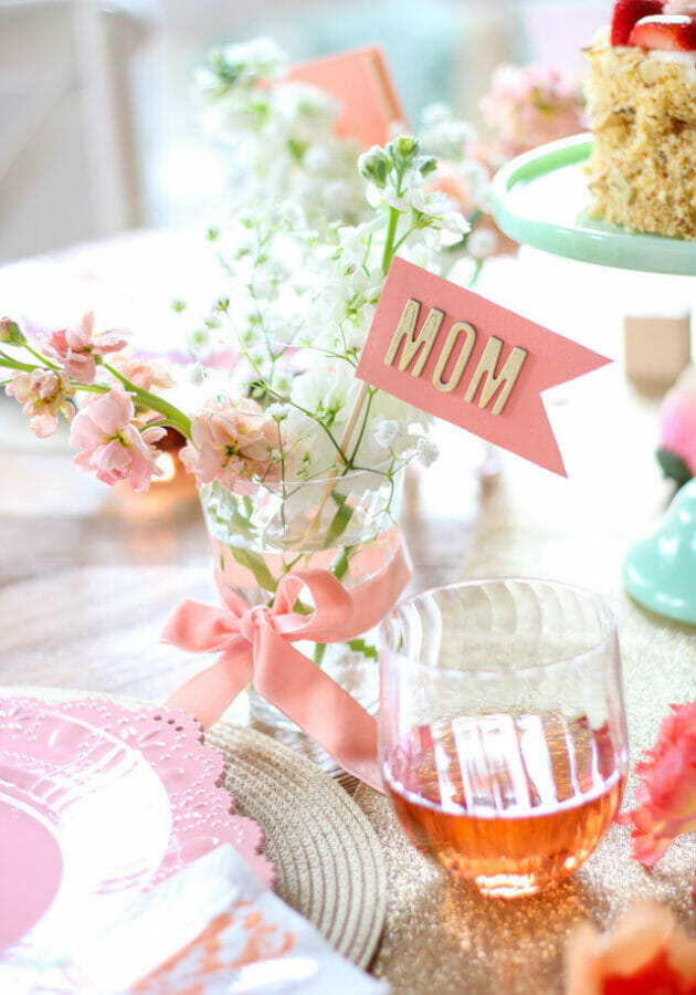 pink flowers in glass with pink mom flag
