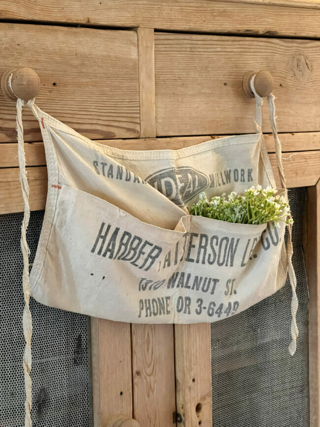 old hardware apron with small white flowers in pocket