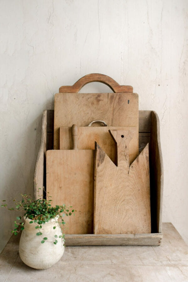 layered wooden breadboards in vintage crate