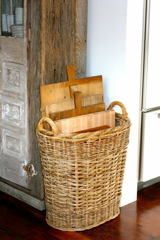 stacked vintage boards inside a standing basket