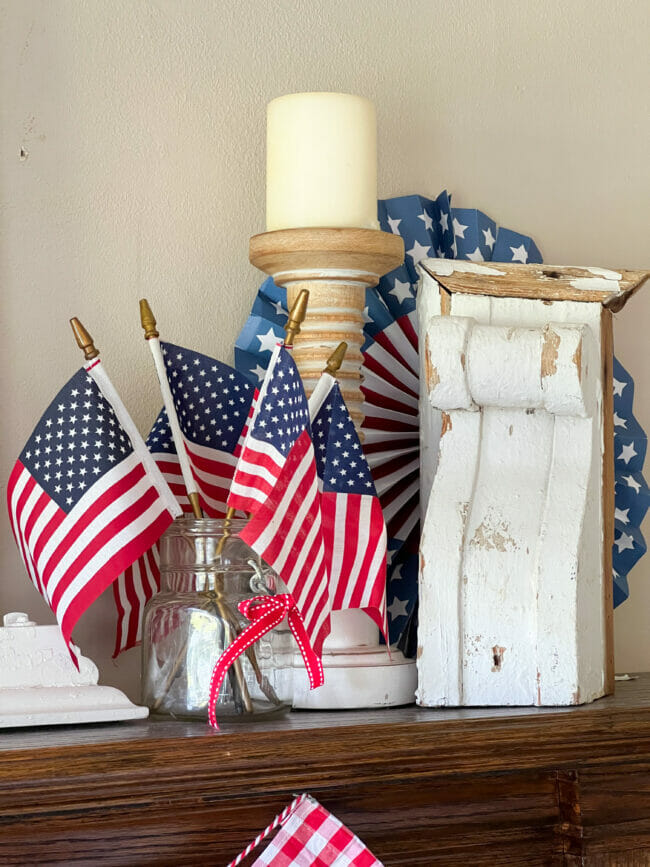 flags in mason jar, candle and white salvage piece