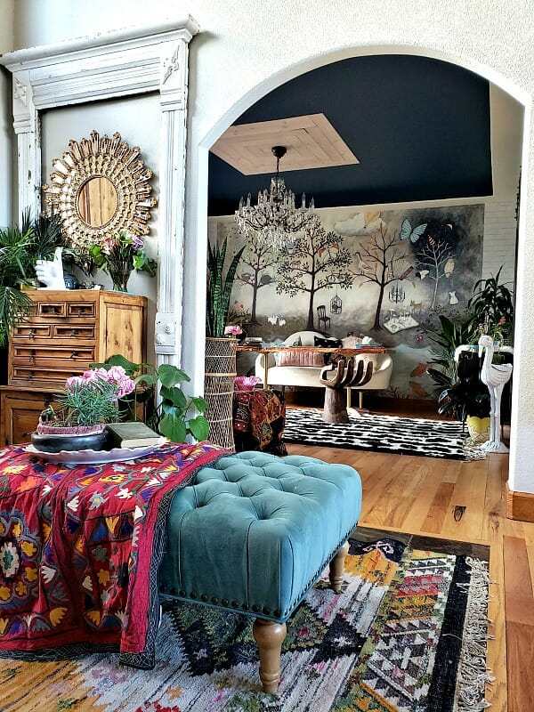 dresser with mirror, plants, colorful furniture, wild wallpaper, navy ceiling