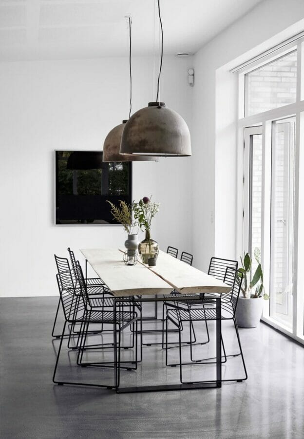 white walls, dining table with plant and black blank wall art