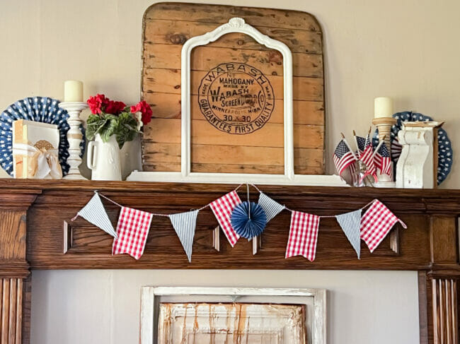 close up of mantel with flag garland and repurposed pieces
