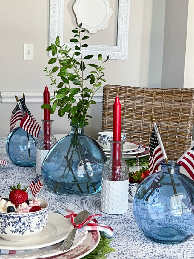 patriotic tablescape with blue jars, red candles and flags