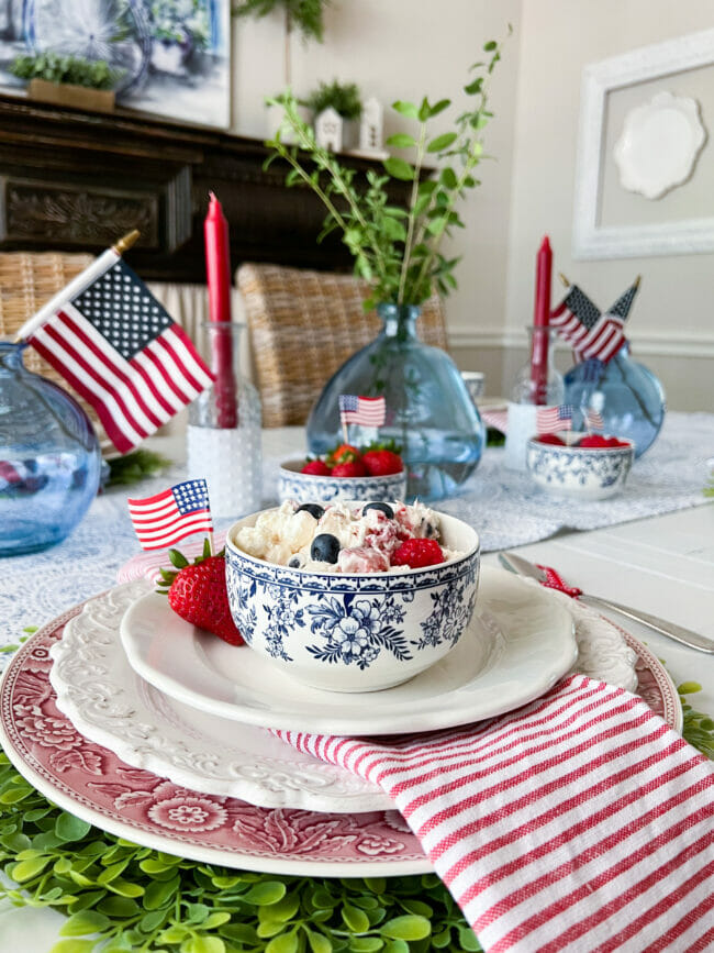 red, white and blue place setting with red candles and blue jars