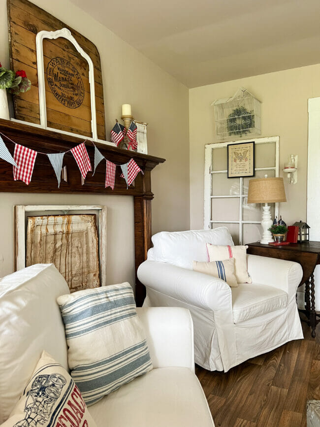 white chair, flag garland on mantel, lamp etc.