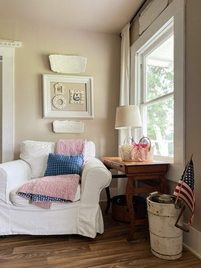white chair with patriotic quilt, window and flags