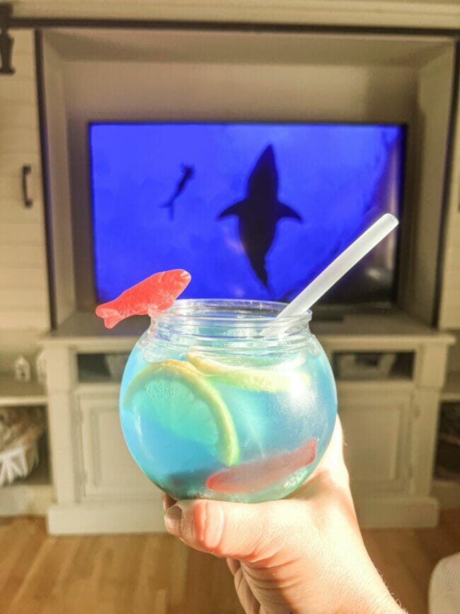 fishbowl drink with shark on TV in background