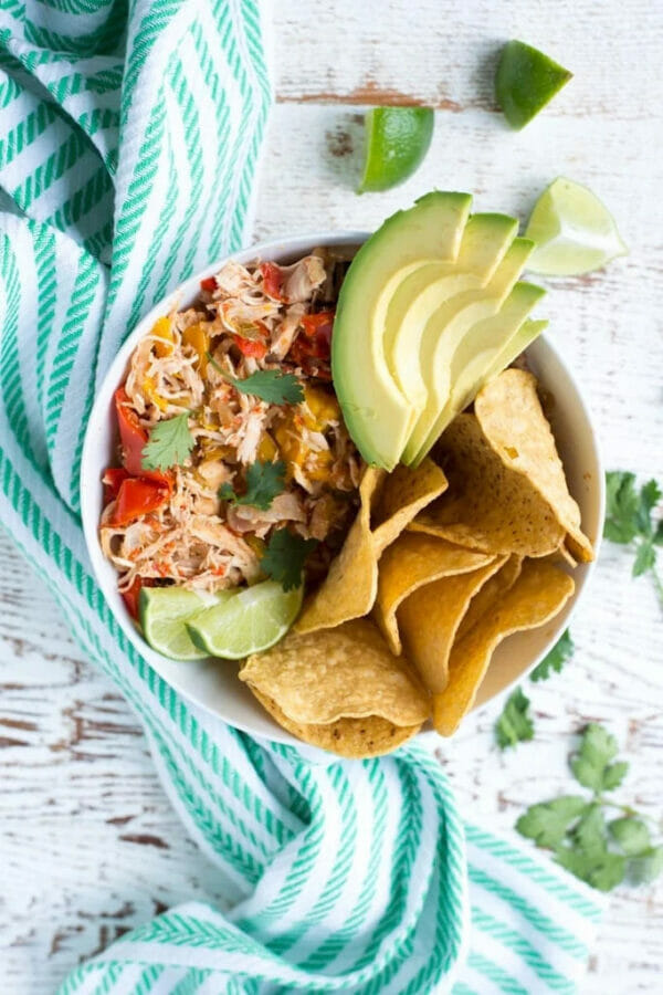 chicken, avocado, chips on white bowl