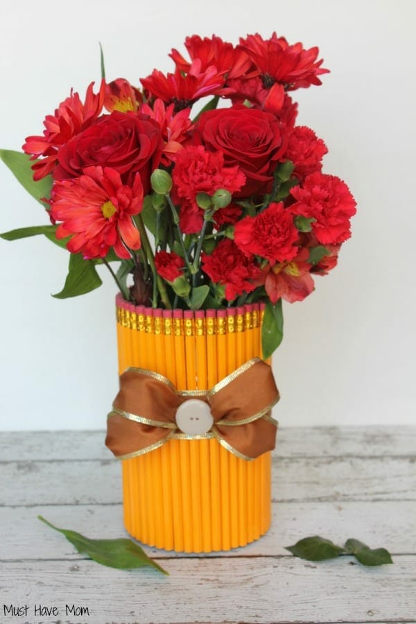 pencil vase with red flowers