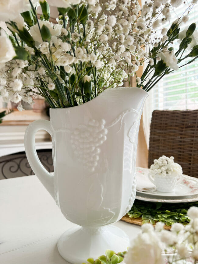 white milk glass pitcher with flowers