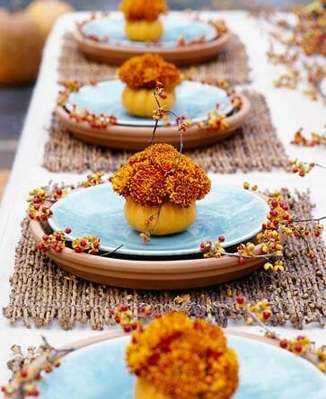 orange pumpkins with mums as place cards or markers on plate