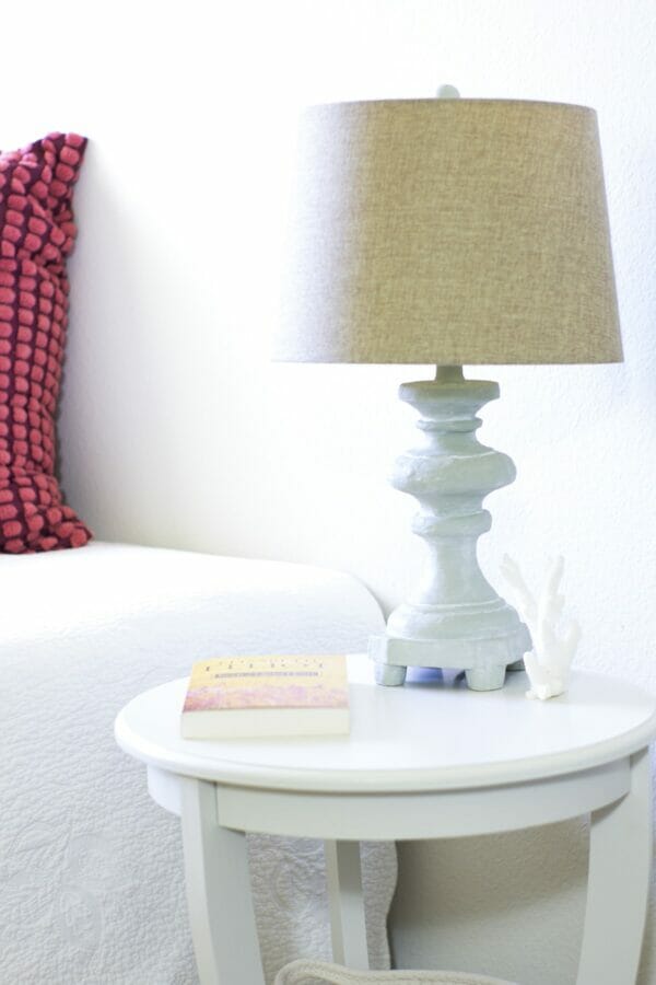 pale lamp on white table with book