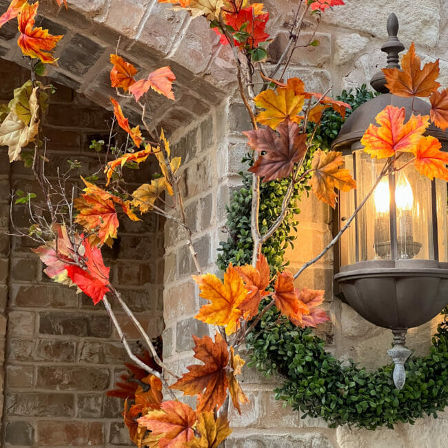 fall leaves with boxwood wreath around the light fixture