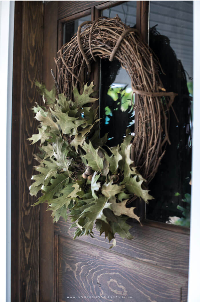 oak leaf grapevine wreath hanging on wooden door