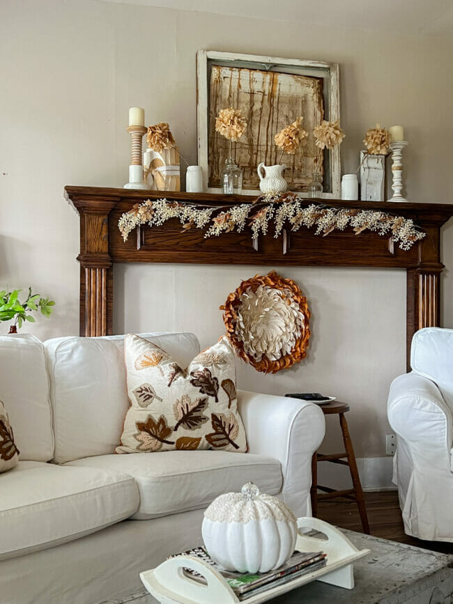 white sofa, fall mantel with feather medallion