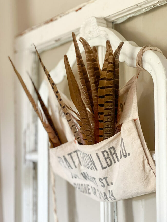 feathers inside hanging vintage hardware bag